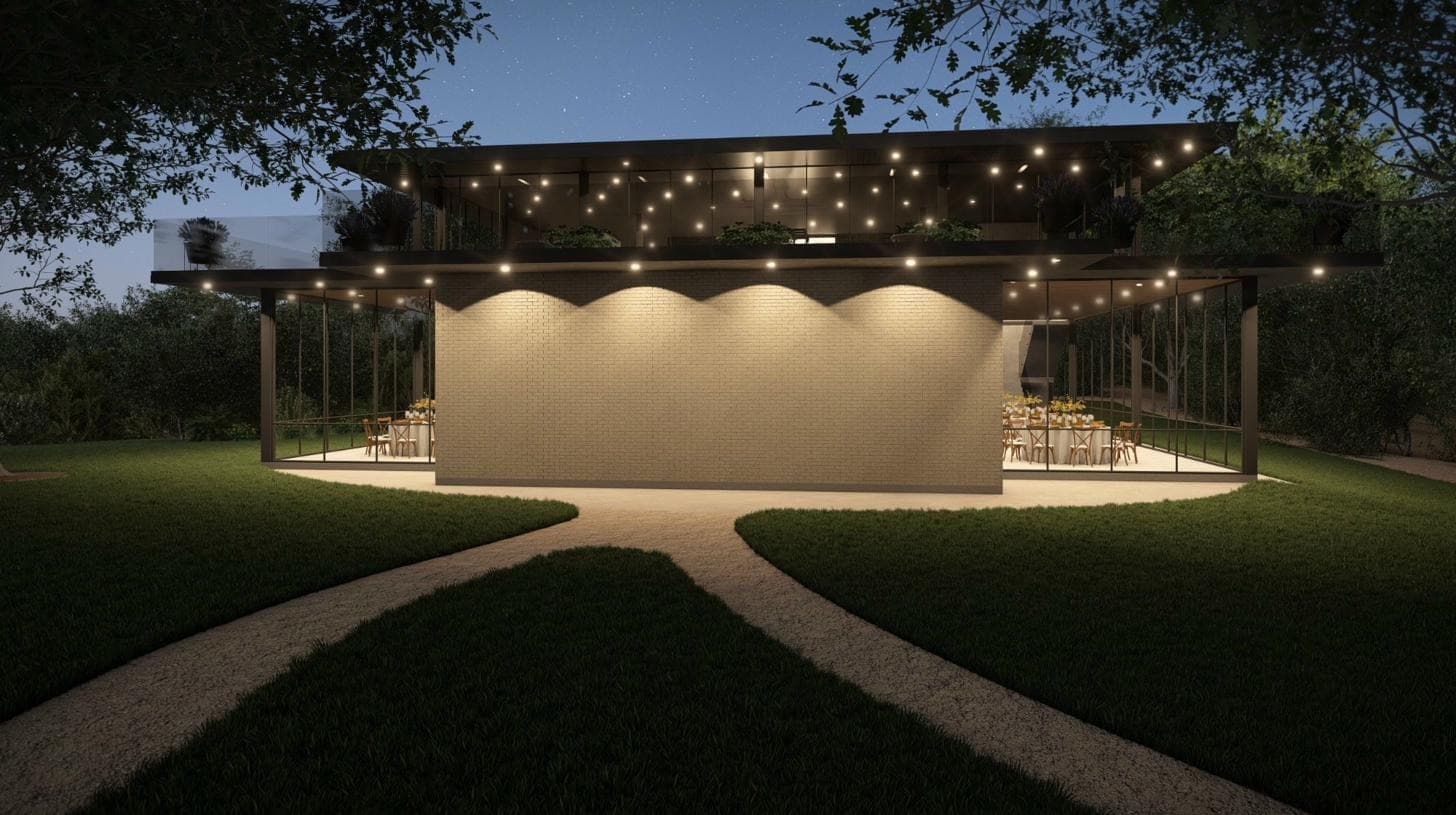 Glass House at night, exterior glowing beneath strands of string lights