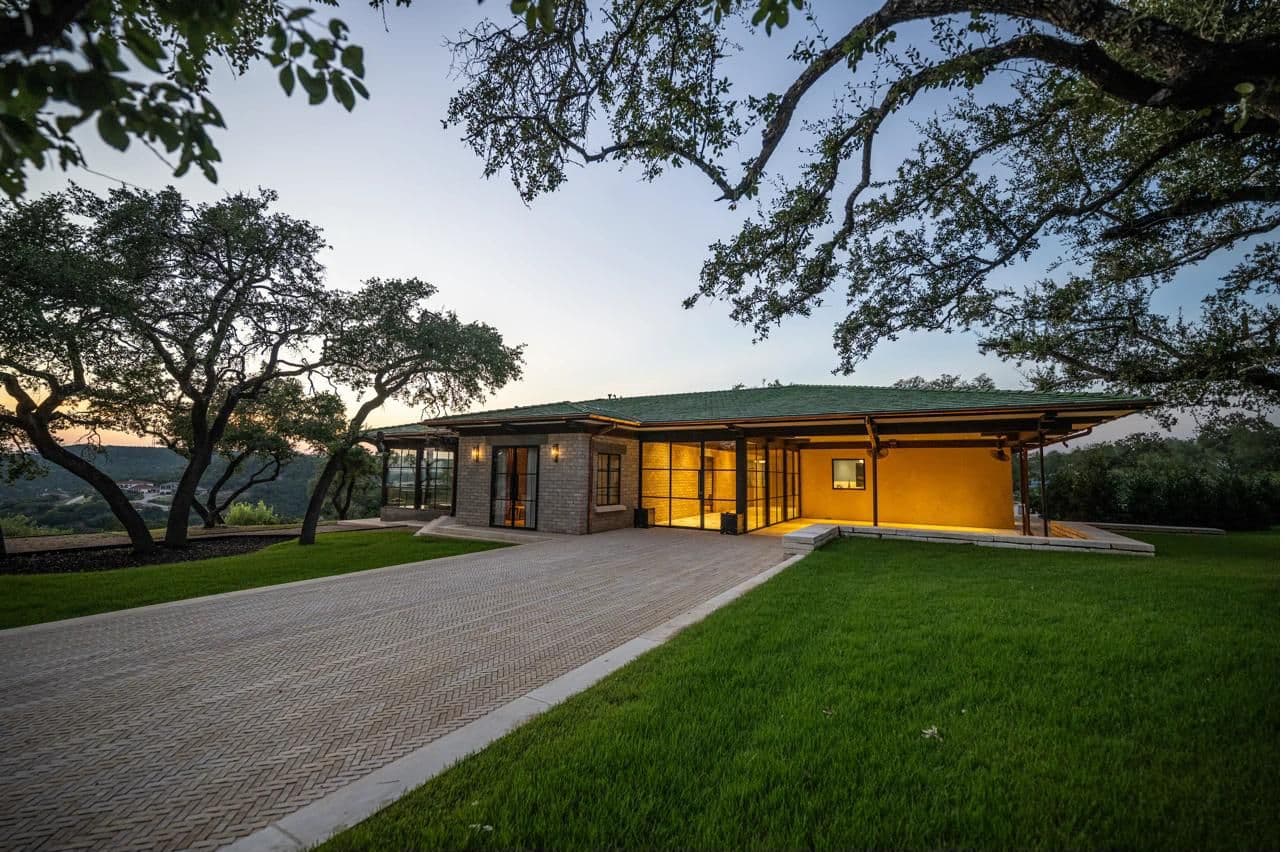 Luna Manor at dusk with warm interior glow