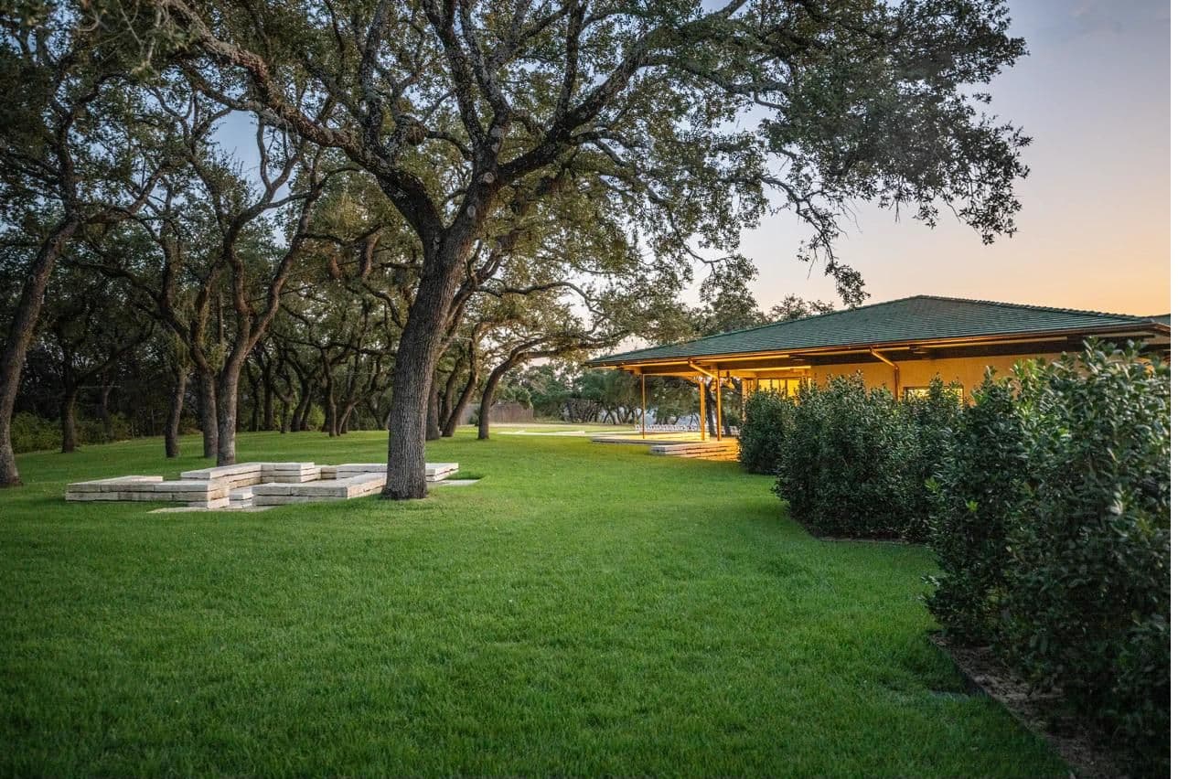Moon Flower Hill grounds at golden hour, rolling lawns and oaks