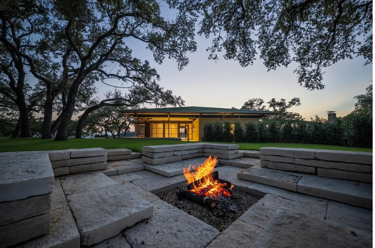 The Veranda fire pit with stone seating at dusk